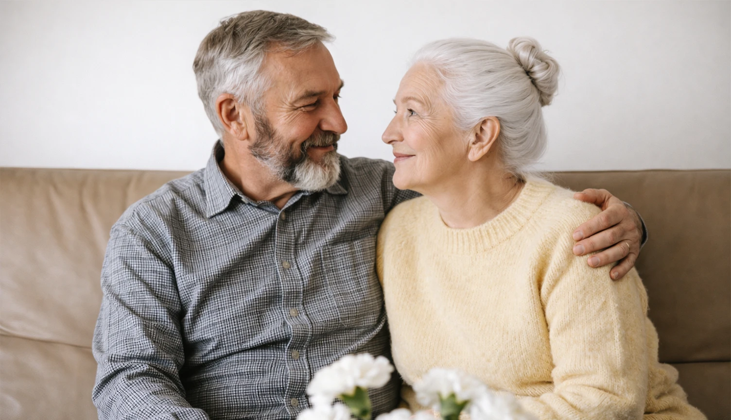 Elderly couple sitting together at home
