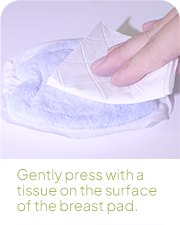 Pressing tissue on breast pad surface